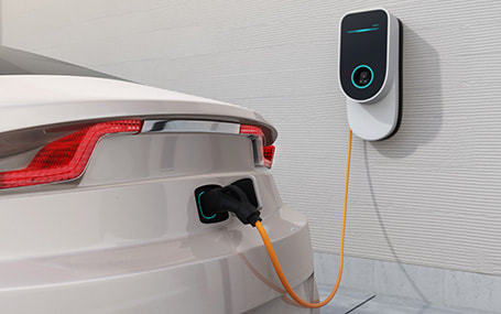 3D render of EV charger installed in home garage charging an electric car