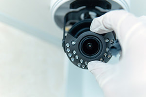 Closeup of an electrician installing a cctv security camera