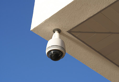 Domestic security camera installed in the corner of a house