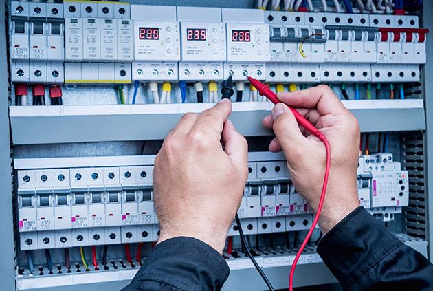 Electrician performing routine electrical safety check for rental compliance