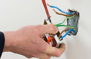 Electrician repairing a light switch