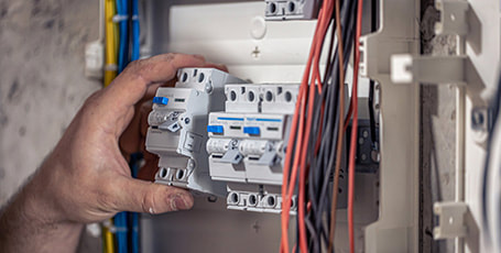 Electrician repairing a safety switch