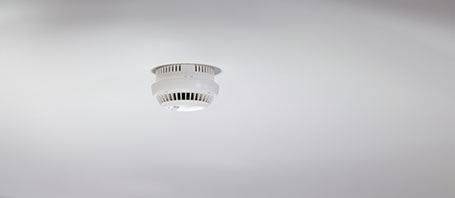 Focus photo of smoke alarm installed on a ceiling