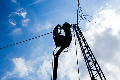 Grade A electricians repairing overhead wires