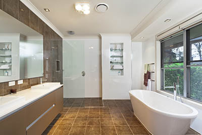 Modern bathroom with heating lamp installed in ceiling